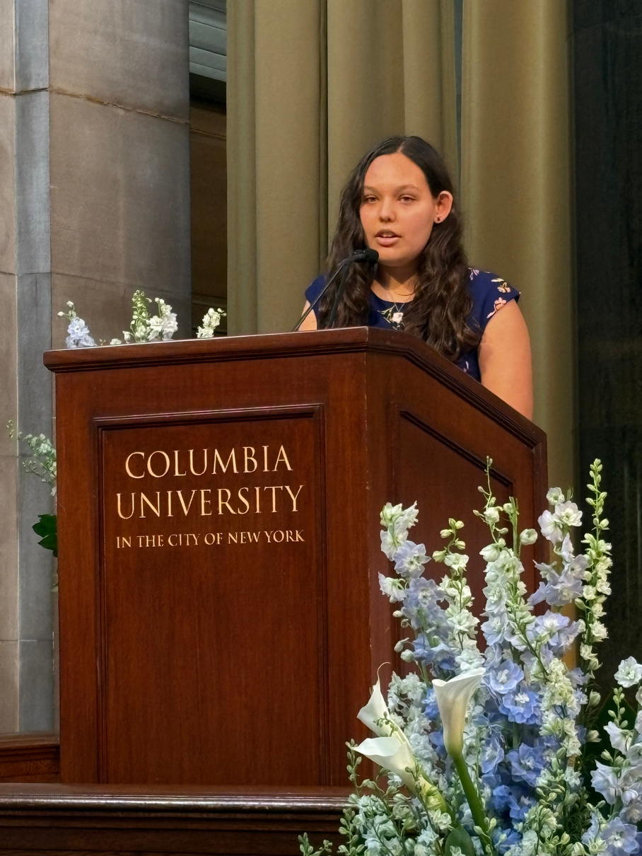 Maya speaking at a Columbia University podium